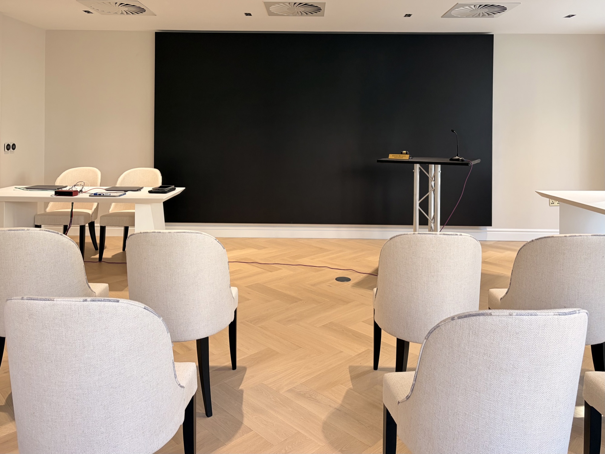 The auction room's video wall and rostrum with rows of seating